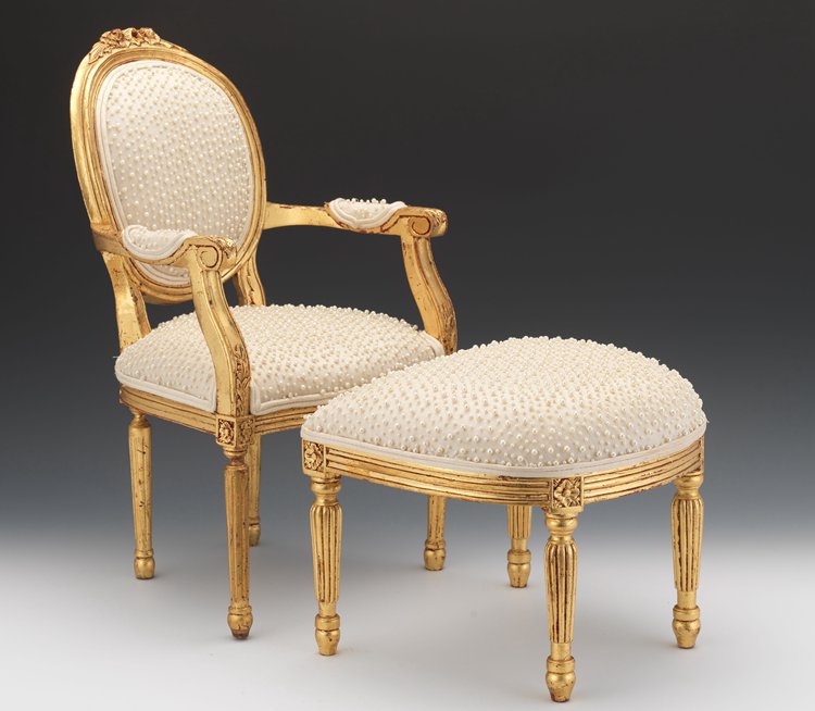 A Louis XVI-style fauteuil gold foiled chair with faux pearls and ottoman