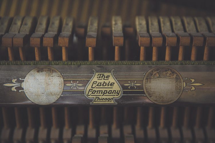 The Cable Co.'s label inside a piano