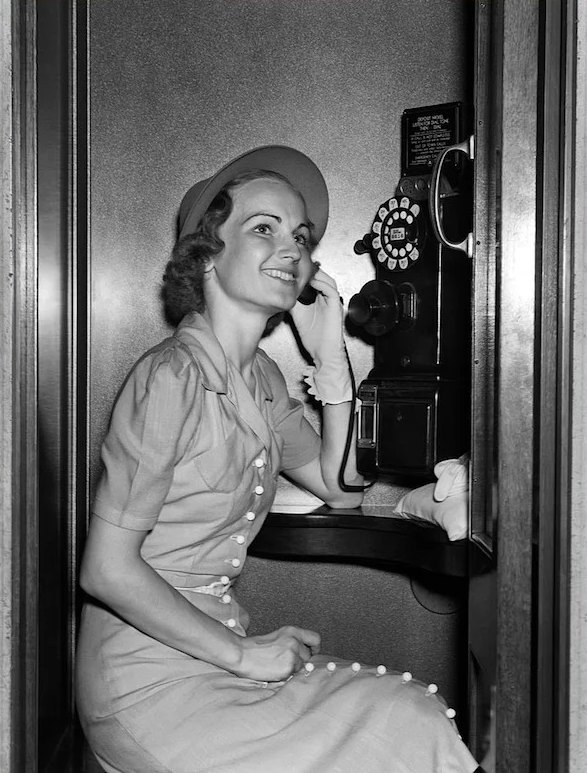 Woman using a pay phone circa 1930s