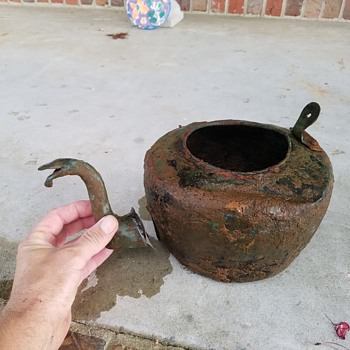 An 1800s antique tea kettle in terrible condition