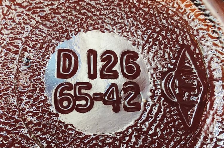 Owens-Illinois Glass Company amber bottle base with “65” liquor bottle permit number, along with 1942 date code. The LBPN “65” indicates this bottle was made at their Streator, Illinois glass plant. The “D 126” is a distiller code number for Seagram’s. The “Diamond / oval / I” trademark used by Owens-Illinois is placed to the right, and tipped on its side.