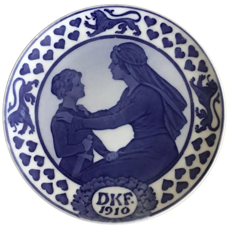 A Royal Copenhagen plate with an image of a woman with boy carrying a sword
