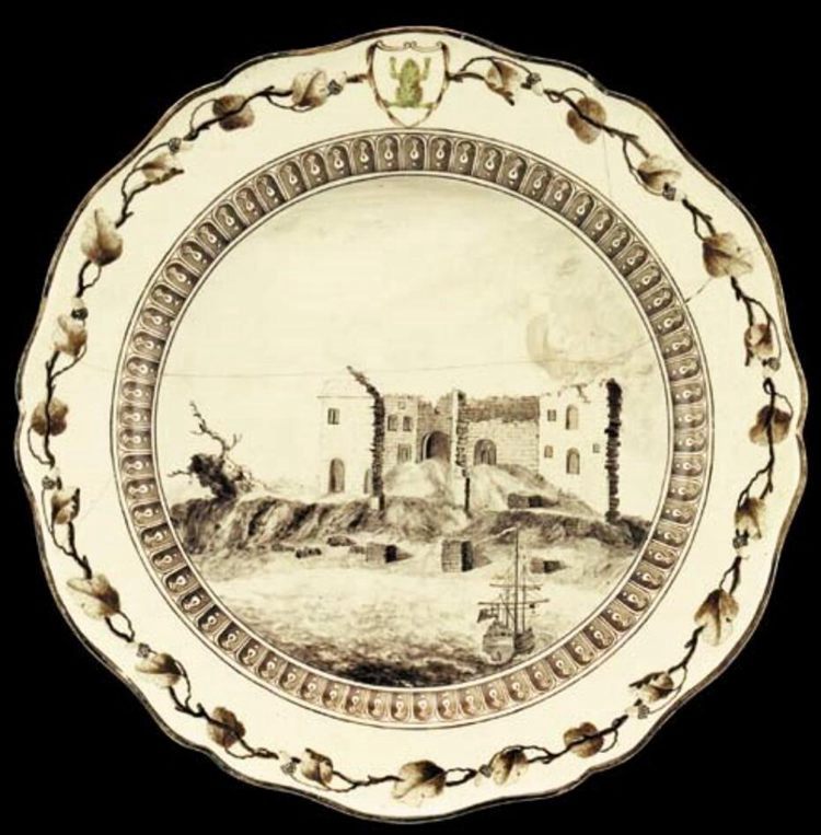 A cream-colored plate with a building design in the center