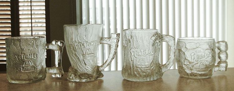 A set of four 3D realistic-looking Flintstones glasses