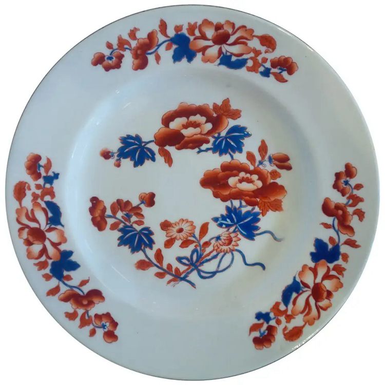 A white plate with blue and red flower designs