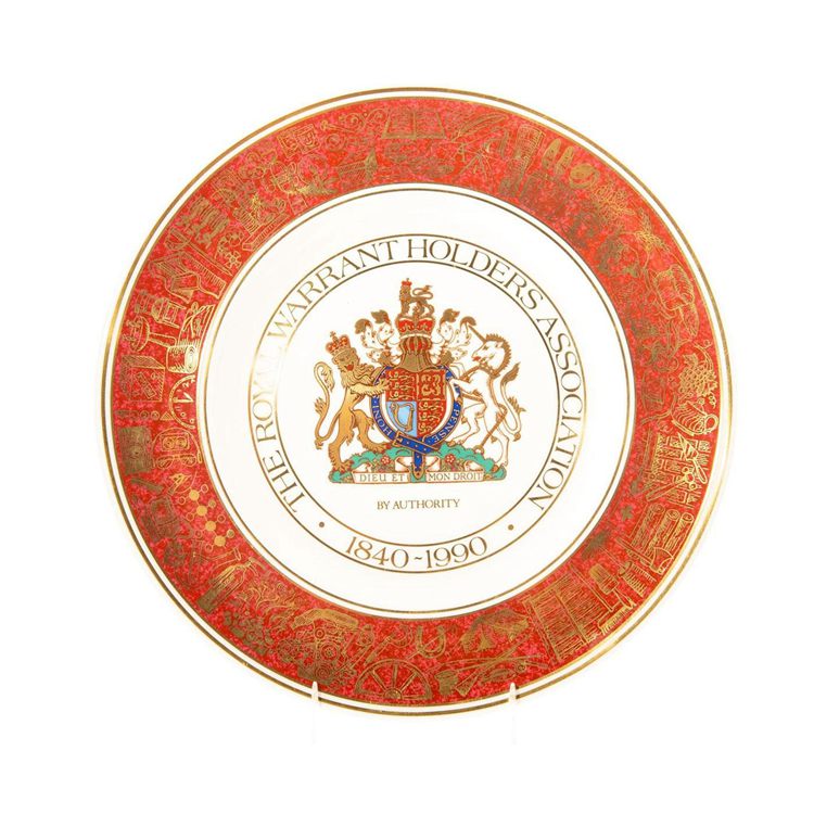 Red, white, and gold plate with a coat of arms in the center